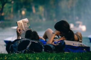 Two ladies on the grass reading in the outskirt of Lagos.